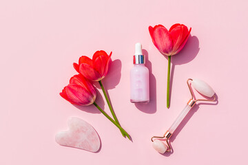 Rose Quartz Roller Massager, Gua Sha Scraper, Rose Massage Oil in Dropper Bottle for Home Face and Neck Massage. Beauty and health concept.