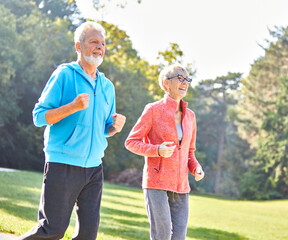 woman senior man outdoor running couple lifestyle sport smiling together jogging healthy nature fit happy active retirement exercise fitness run