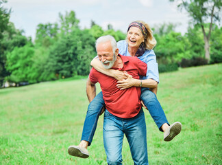 senior people couple happy elderly love together retirement  man woman mature piggyback fun