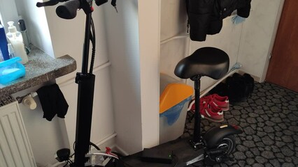 Electric scooter is charging in an apartment or in a student dorm room