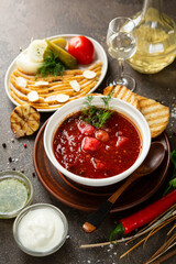 borscht in a white bowl with lard and sour cream
