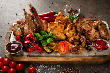 Close up of  grilled meat of different types beef pork dark surface