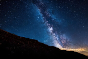 Cosmic Canvas. Vibrant Milky Way over tranquil hills, suitable for book covers, posters, or astronomy guides.