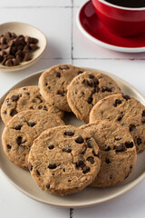 Delicious chocolate chip cookies with a red coffee cup. Breakfast. 
