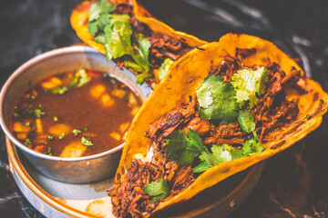 Beefy Birria Tacos made using 8 hour slow cooked chuck with beef consommé on the side
