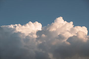 Fluffy, soft white cumulus clouds in blue sky, natural background