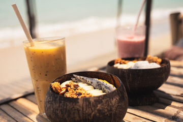 Smoothie Bowl in a coconut bowl with various kinds of fruits at the beach in. ko pangan