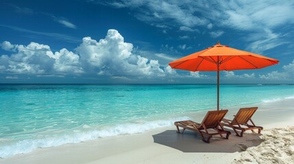 Obraz premium Two chairs placed on a sandy beach under a bright orange umbrella, overlooking the ocean on a sunny day