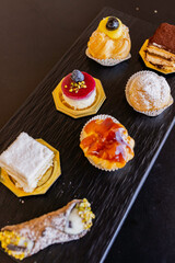 Vassoio di monoporzioni di torta e di piccola pasticceria artigianale servito in un bar elegante