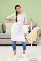 Woman, tired and mop floor in home, hygiene and thinking to stop germs, bacteria and dust with...