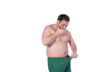 Men's health and erection problems. Fat man posing on a white background.