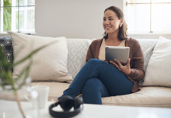Woman, home and sofa with thinking on tablet for social media post and entertainment in living room. Female person, internet and streaming service or website for news update or online search