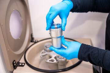 Expertise placing samples in a centrifuge machine in a laboratory