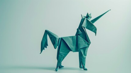 Naklejka premium Origami unicorn. Animal made of paper on a grey background. Paper folding art.