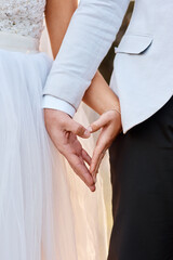 Wedding, couple and holding hands with love in heart or partnership with kindness and care....