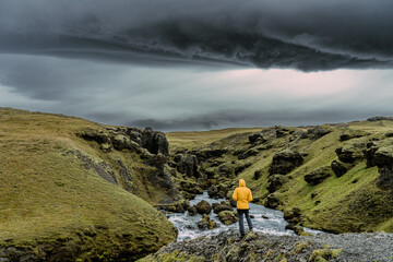 Skógá River under a stormy sky. Long river runs through the Highlands of Iceland, summer storm,...