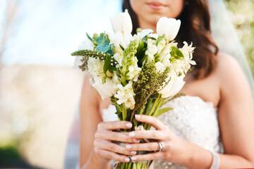 Woman, bride and hands with bouquet of flowers for wedding, marriage or ceremony in outdoor nature....