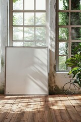 A large, blank white canvas stands in the center of an elegant room with wooden floors and tall windows that look out onto lush greenery outside