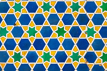 Vintage cracked tile with geometric arabic pattern on the mosque wall as texture or background