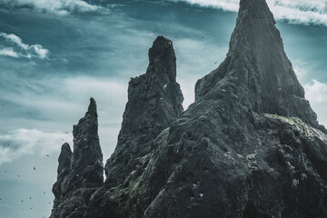 Reynisdrangar, black beach in Iceland. Famous basalt sea stacks under the mountain Reynisfjall, near the village Vík í Mýrdal. No people.