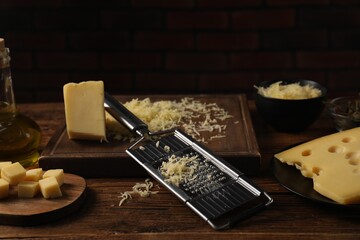 Different types of cheese and grater on wooden table - obrazy, fototapety, plakaty