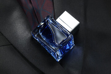 Luxury men's perfume in bottle on black jacket