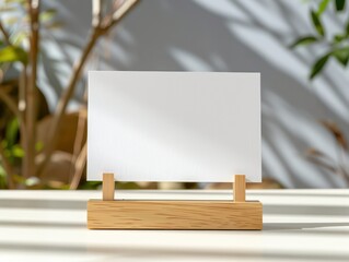 horizontal postal card in wooden stand, on top of a table
