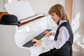A young boy is playing the piano .