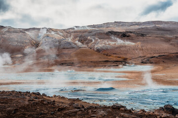Námafjall Geothermal Area. Tourists in the distance, steaming fumaroles, boiling mud pots....