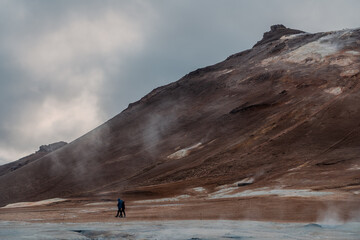 Námafjall Geothermal Area. Tourists in the distance, steaming fumaroles, boiling mud pots....