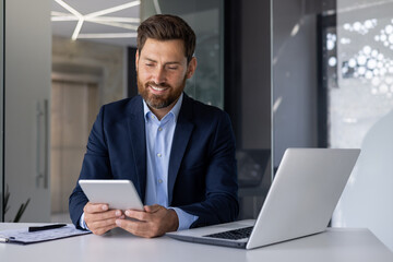 Businessman using tablet in a modern office setting