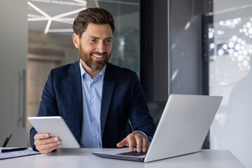 Professional business man working with laptop and tablet