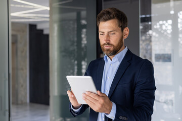 Businessman using tablet in modern office setting