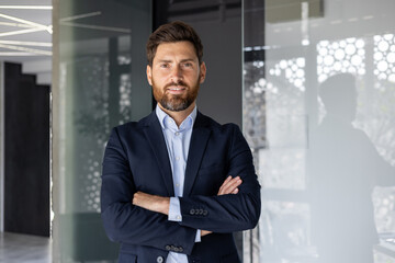 Confident businessman standing in modern office space