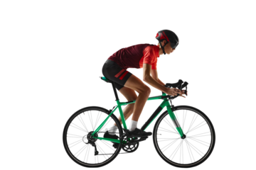 Young man, cycling athlete in sportswear and helmet riding bicycle, training against transparent background. Side view. Concept of sport, action, competition, power and endurance, health, marathon.