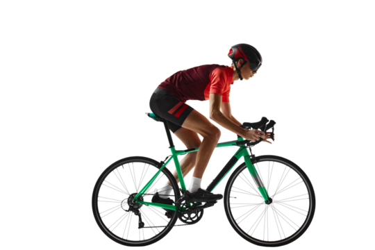 Young man, cycling athlete in sportswear and helmet riding bicycle, training against transparent background. Side view. Concept of sport, action, competition, power and endurance, health, marathon.
