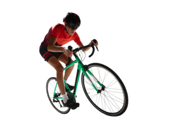 Muscular young man, athlete, cyclist in uniform and helmet, riding bicycle against transparent background. Concept of sport, action, competition, power and endurance, health marathon.