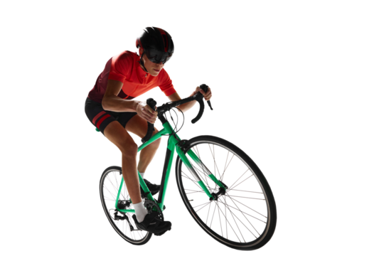 Muscular young man, athlete, cyclist in uniform and helmet, riding bicycle against transparent background. Concept of sport, action, competition, power and endurance, health marathon.