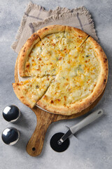 Delicious cheese pizza and cutter on light grey table, flat lay