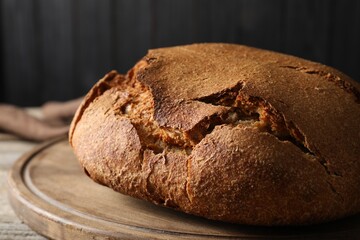 Freshly baked sourdough bread on wooden table, closeup