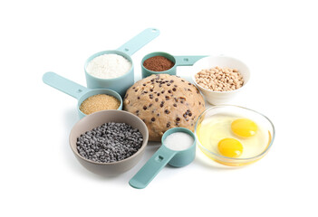 Raw dough with chocolate chips and ingredients isolated on white