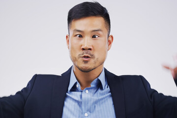 Studio, asian man and silly eyes for comic, funny and crazy expression with emotion. Comedy, male model and goofy face for reaction by white background, quirky personality and humor with emoji
