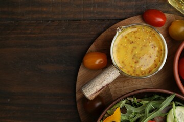 Tasty vinegar based sauce (Vinaigrette), salad and tomatoes on wooden table, top view. Space for text