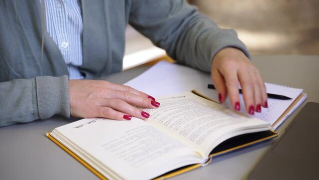 Close up hands scientist write thesis in university library making noted in notebook Mature student exercising in college Freelancer in coworking upgrading professional qualification