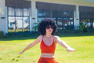 Bright athletic brunette vigorously doing fitness early morning.