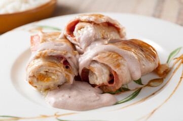 Three turkey steaks stuffed and rolled ham and cheese gratin in oven