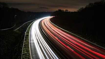 A series of long exposure trails from moving vehicles on a highway at night, weaving a tapestry of red and white lights