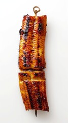A close up image of a skewer of grilled unagi