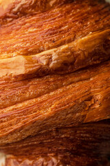 Close-Up of a Golden-Brown Flaky Croissant Crust - Crispy Layers and Buttery Texture Captured in...
