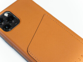 A smartphone with a leather wallet case